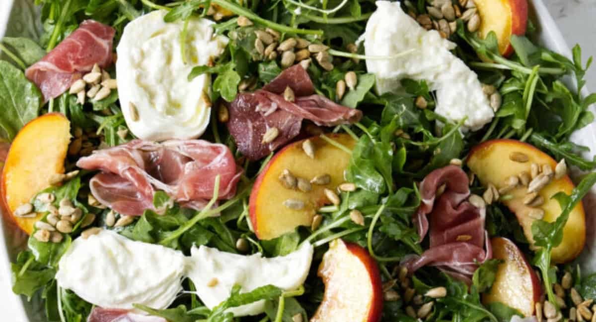 Up close image of arugula burrata salad.