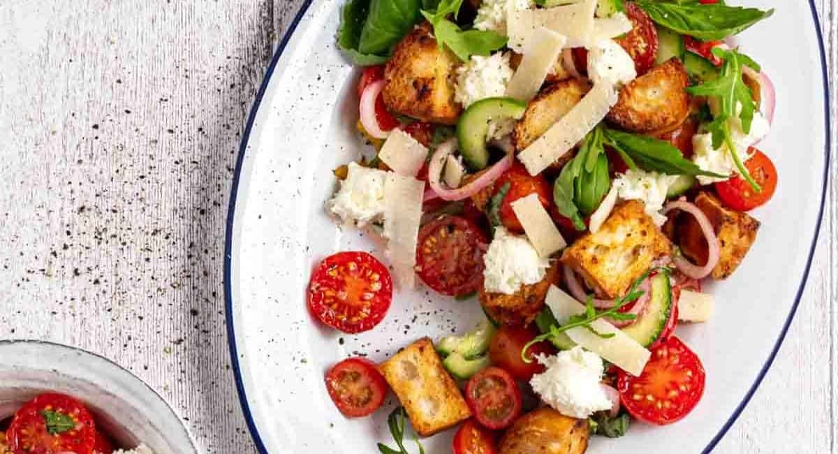 Overhead image of panzella toscana salad on white dish.