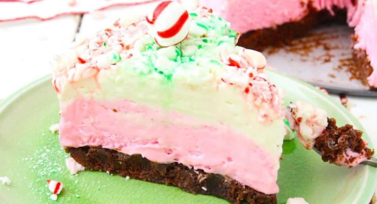 Side image of no bake peppermint cheesecake on green dish.