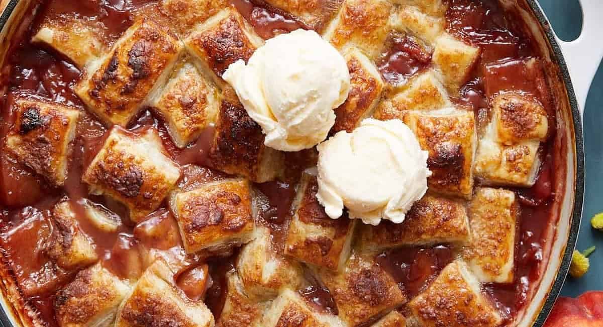 Overhead image of peach cobbler with puff pastry.