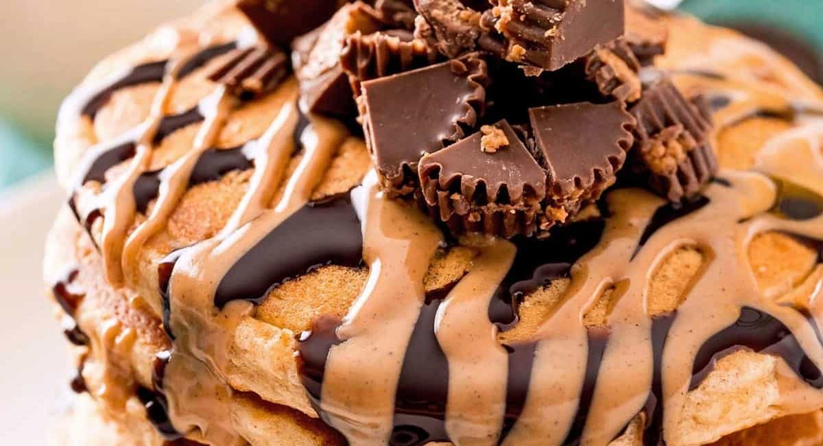 UP close image of peanut butter pancakes with peanut butter cup topping.