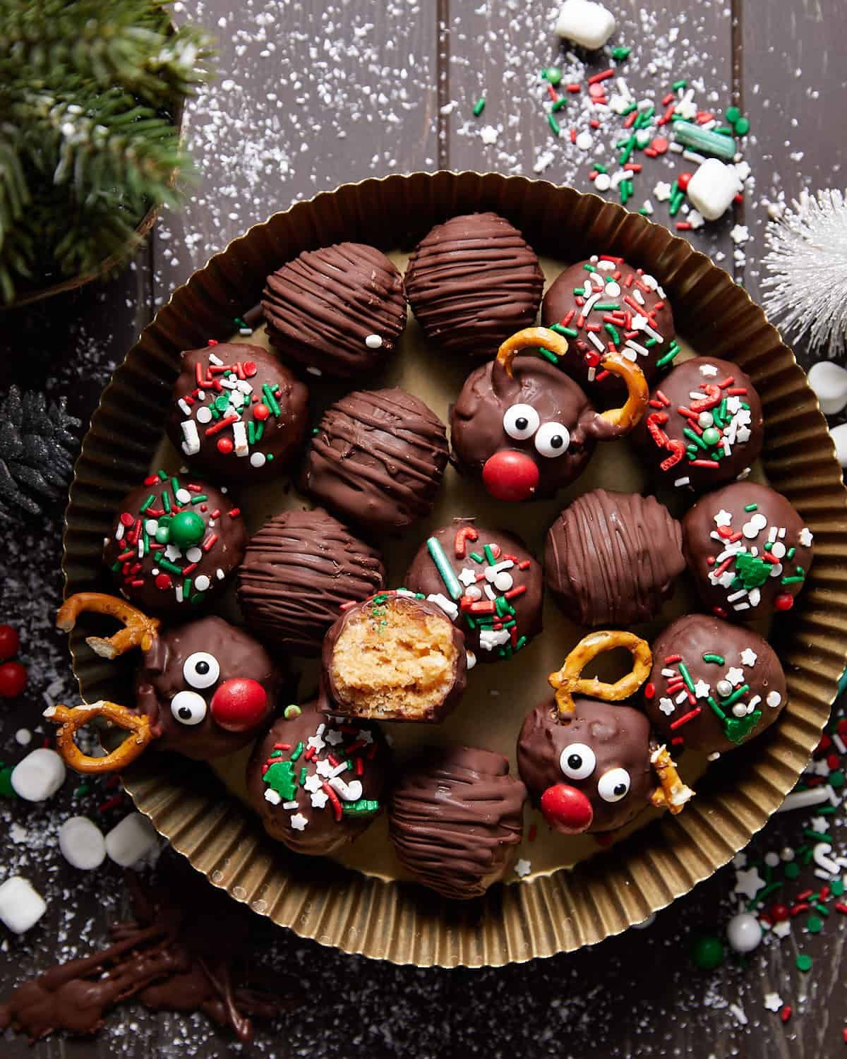 Overhead image of peanut butter balls with rice krispies. Decorated with red, white, and green sprinkles.