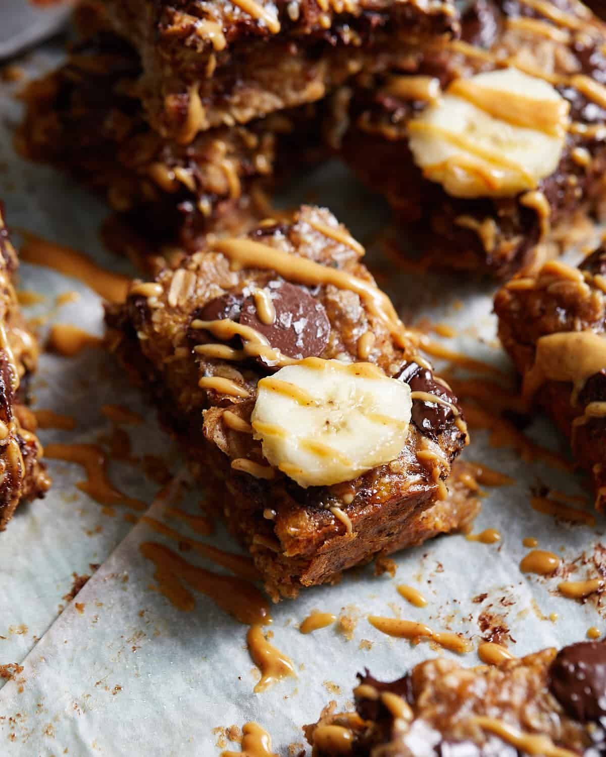 Close up of peanut butter banana bar with chocolate chip and banana slice.