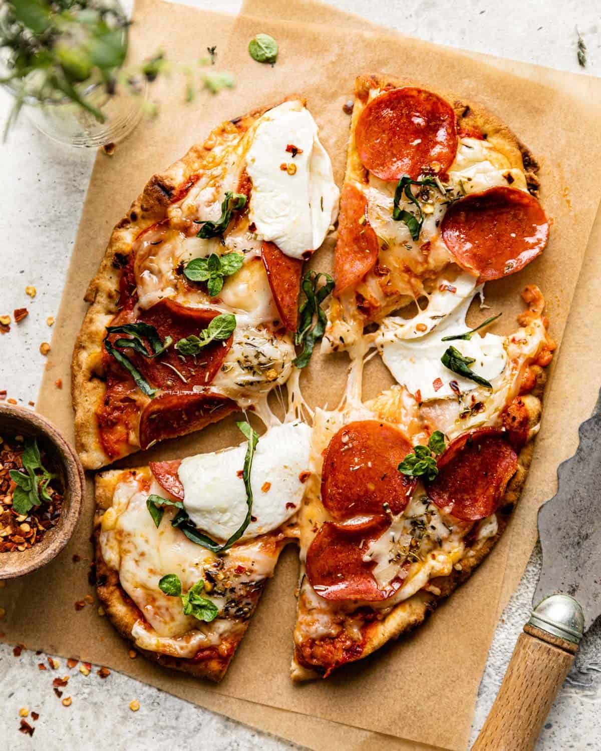 overhead shot of pizza cut on parchment paper