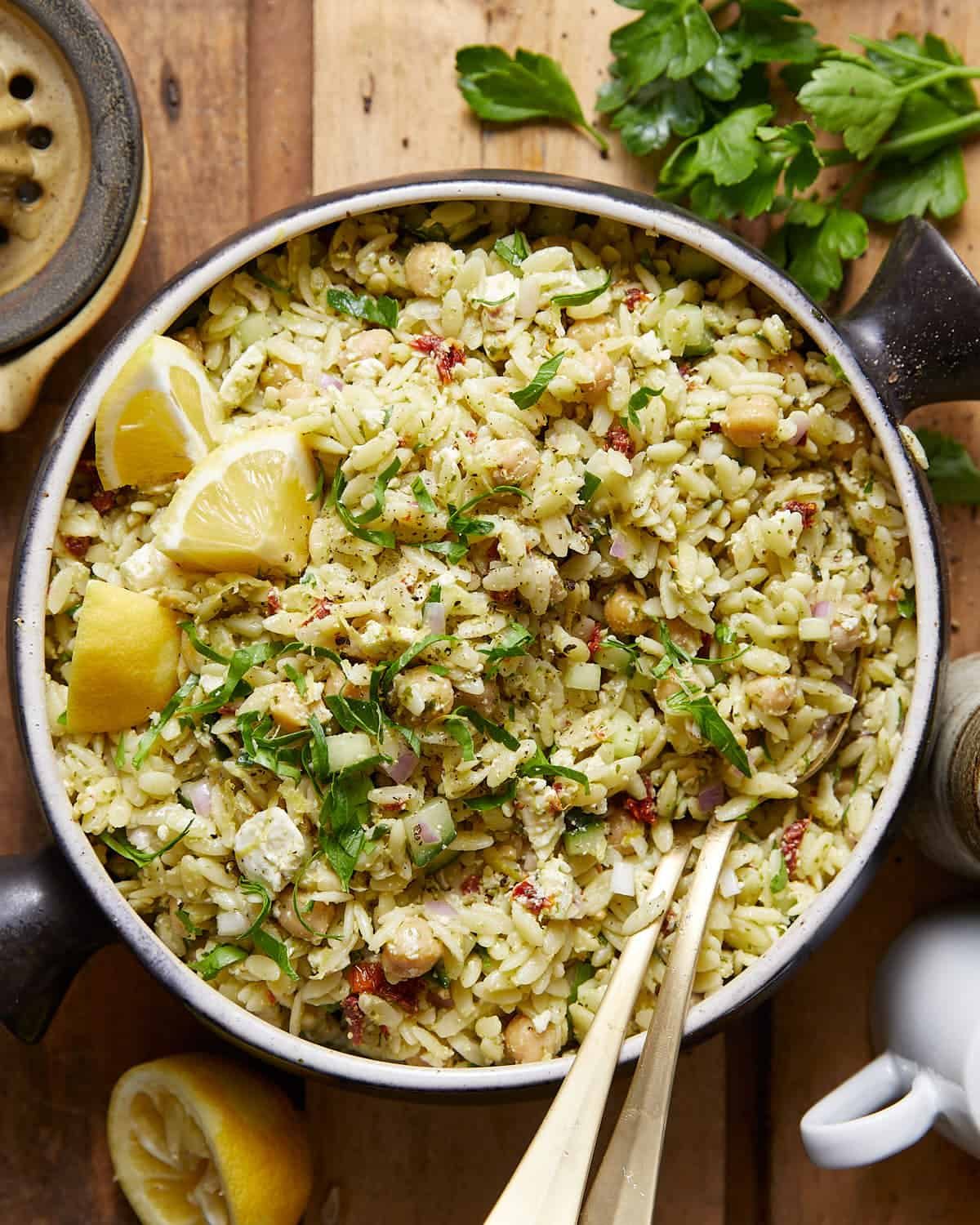 An overhead image of pesto orzo salad with garnish.