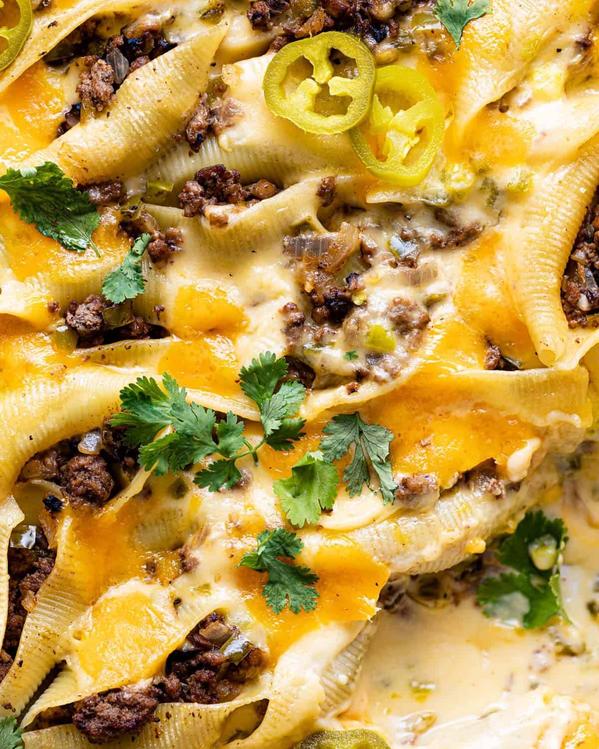 Up close image of Philly cheesesteak stuffed shells with ground beef.
