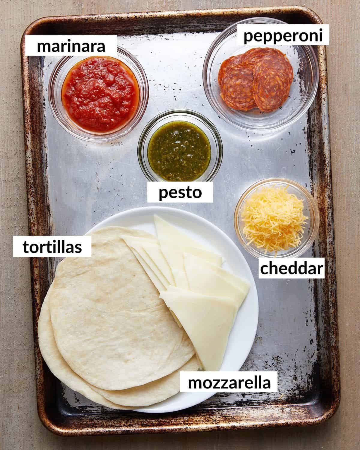 Overhead image of ingredients needed for pizza tortilla wrap.