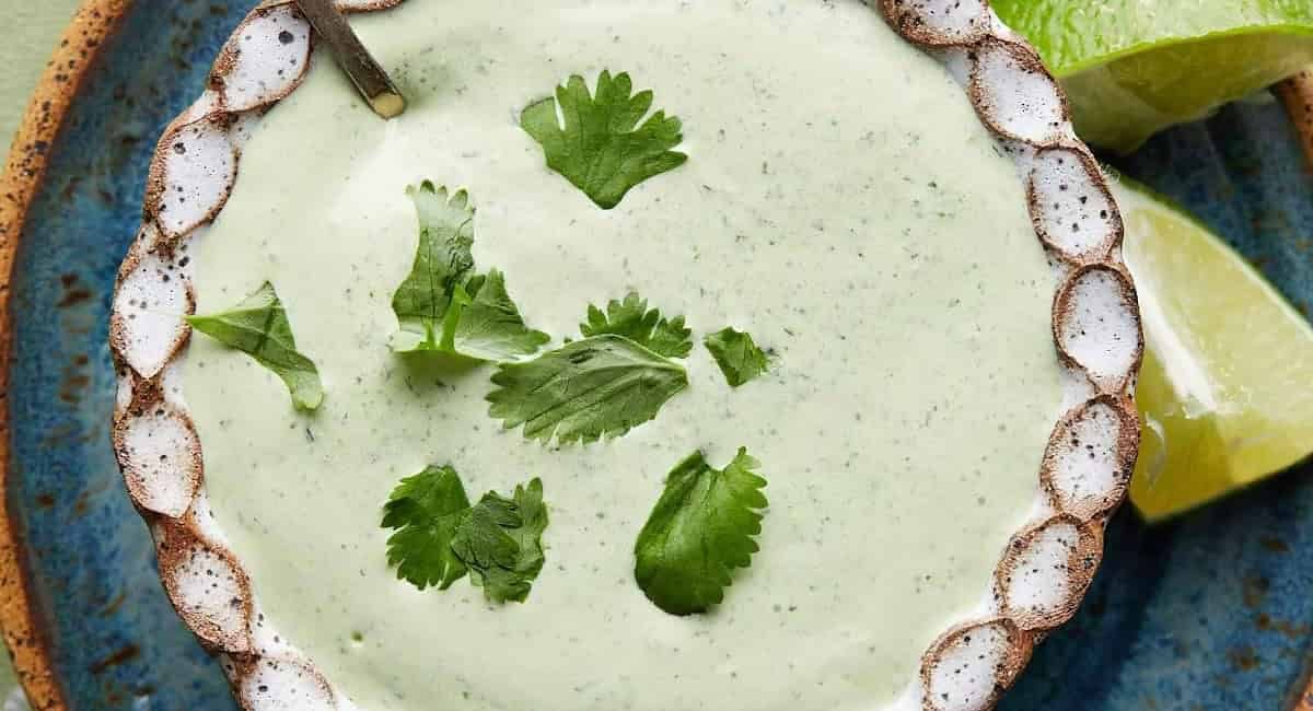 Overhead image of poblano cream sauce with garnish.