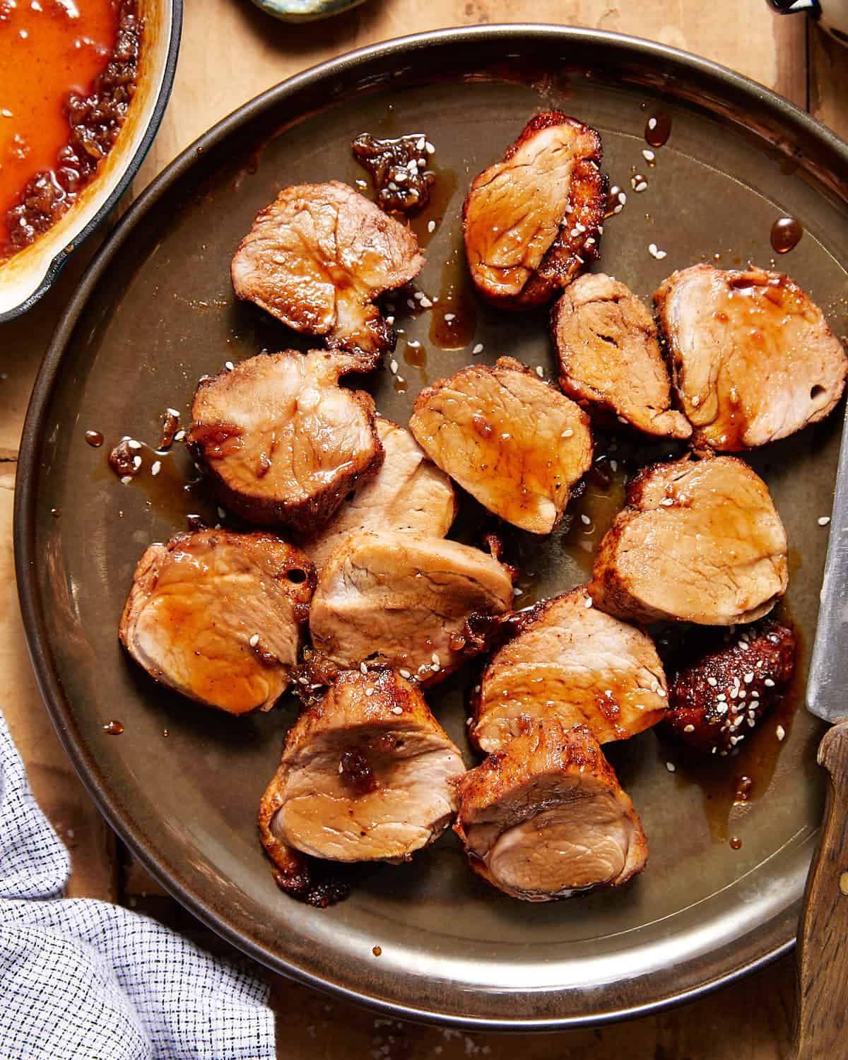 Roasted pork tenderloin sliced with honey soy glaze.