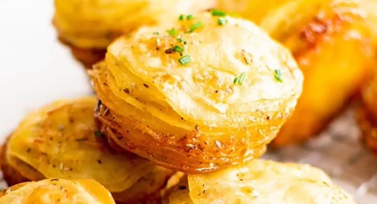Up close image of crispy potato stacks with garnish.