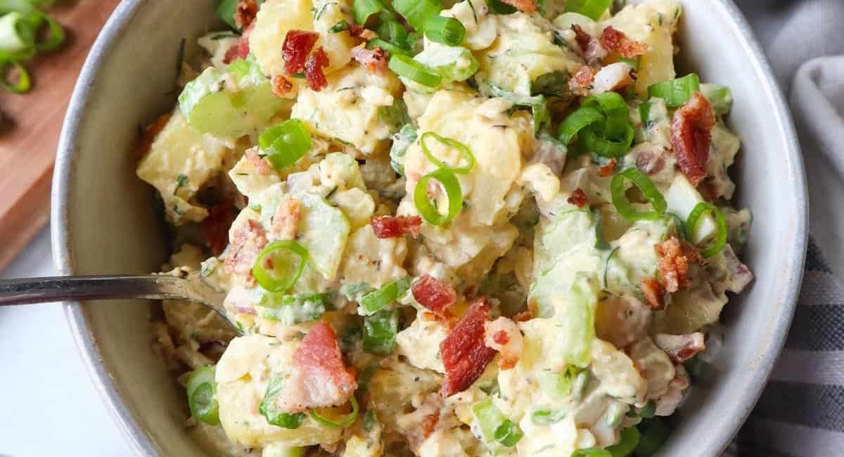 Overhead image of potato salad with spring onions.
