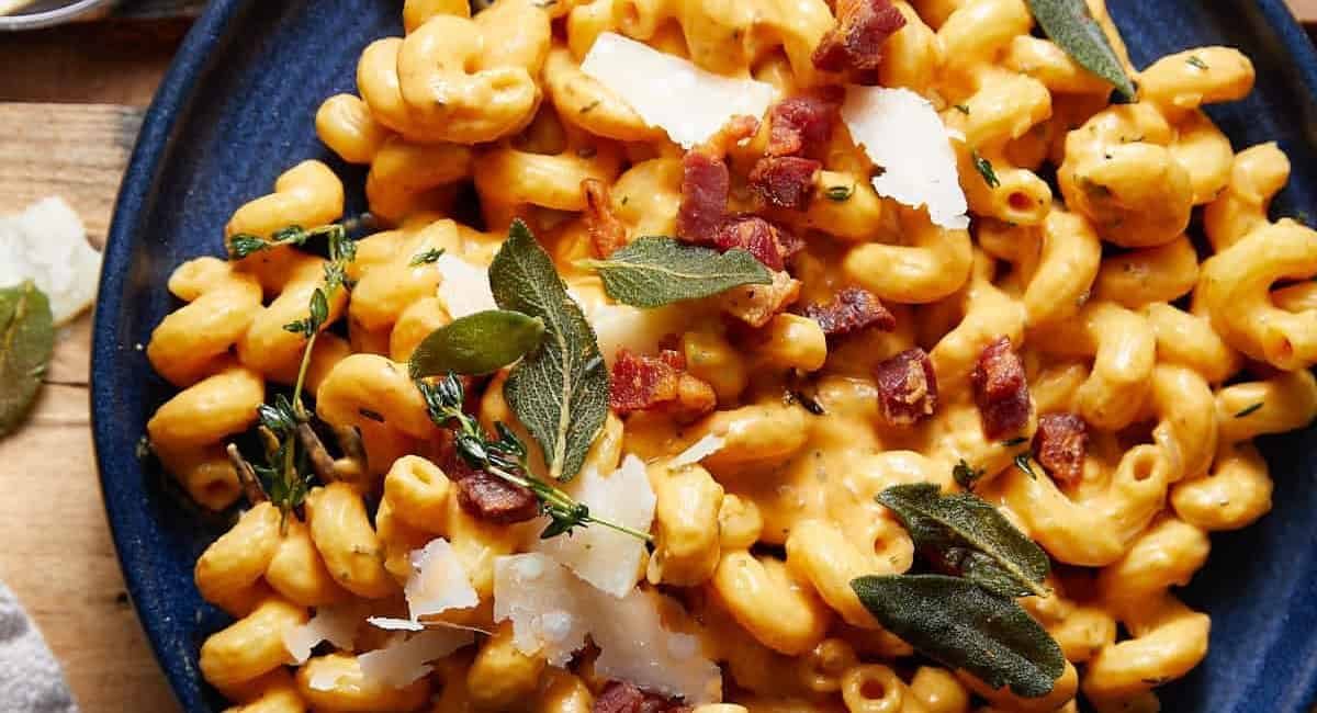 Overhead image of pumpkin pasta sauce with garnish.