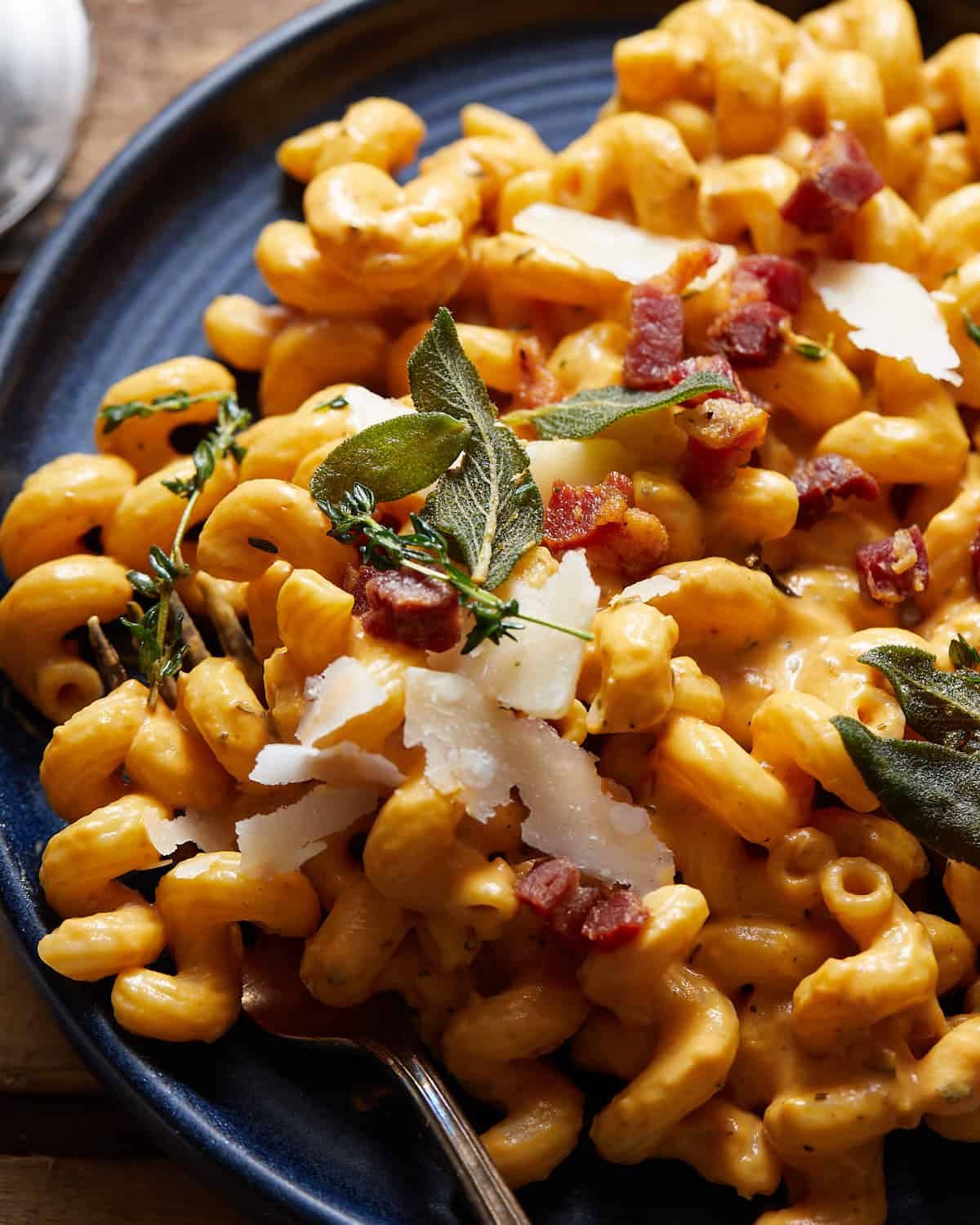 Pumpkin pasta sauce with pancetta and fried sage leaves on top.