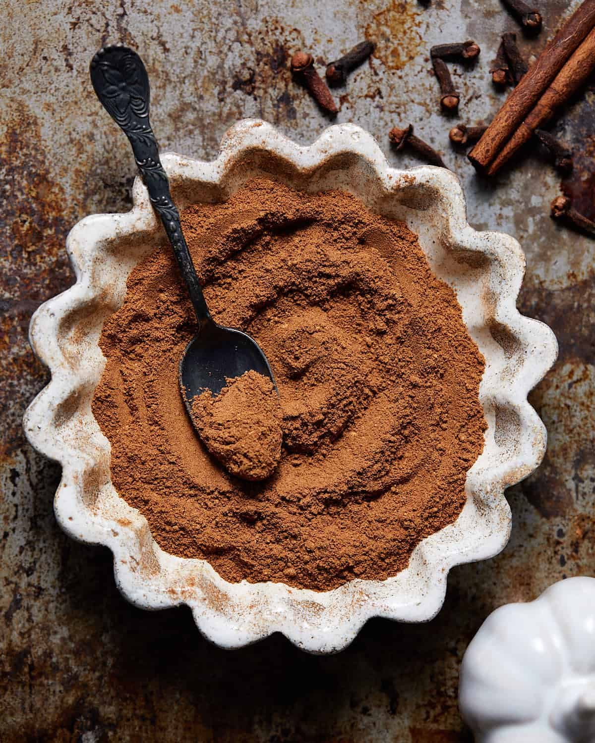 Pumpkin pie spice substitute in a small white dish.