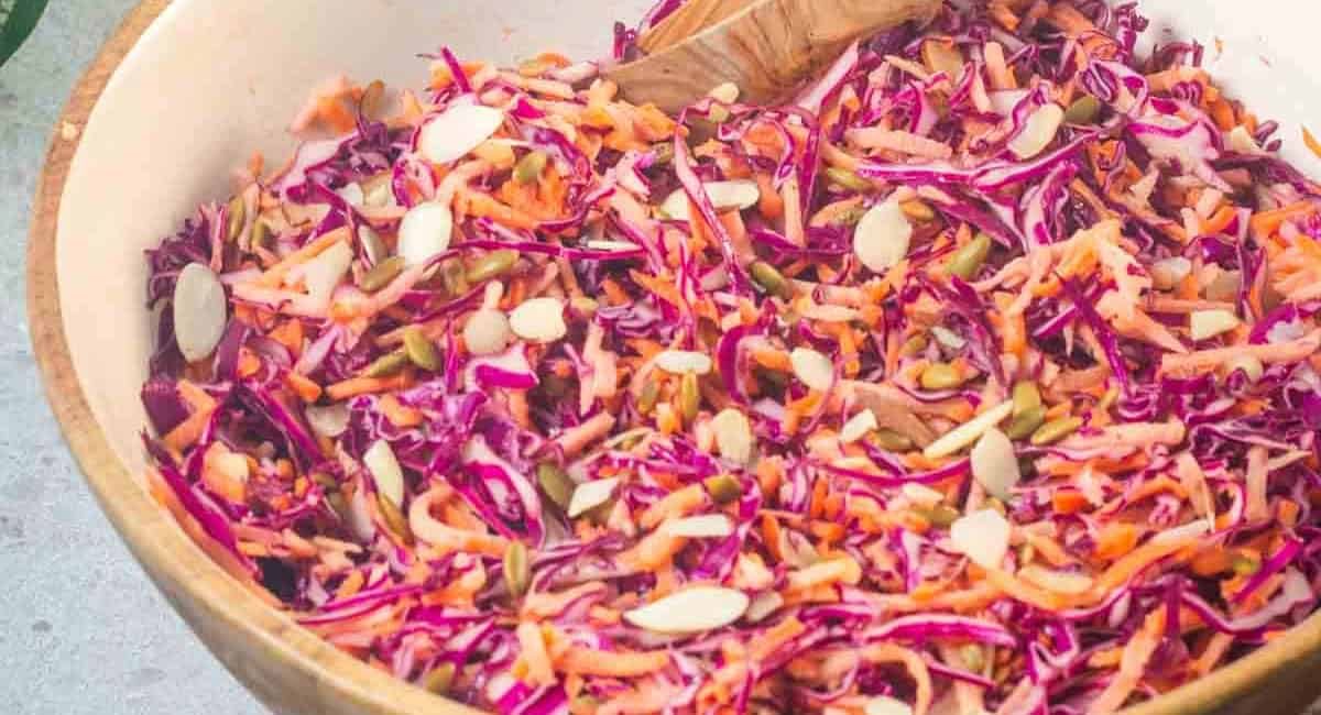 Overhead image of purple cabbage and carrot coleslaw in a bowl.