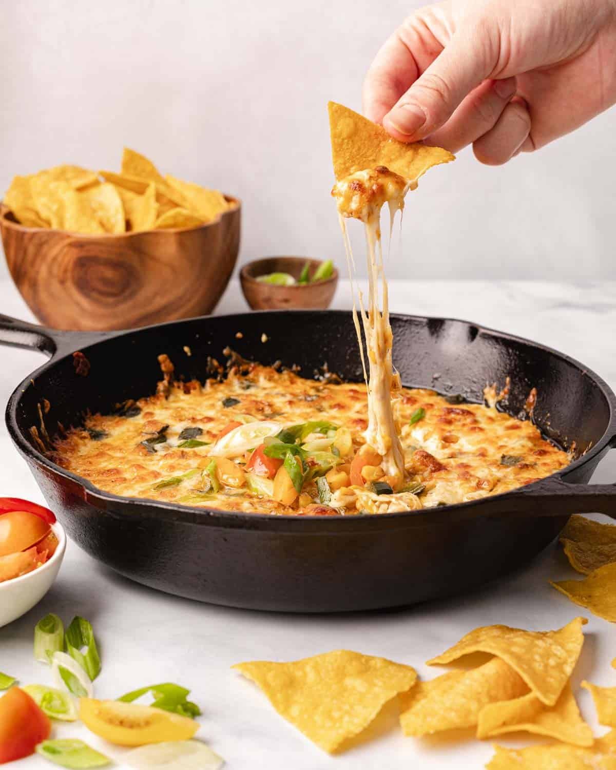 chip dipping into cheese