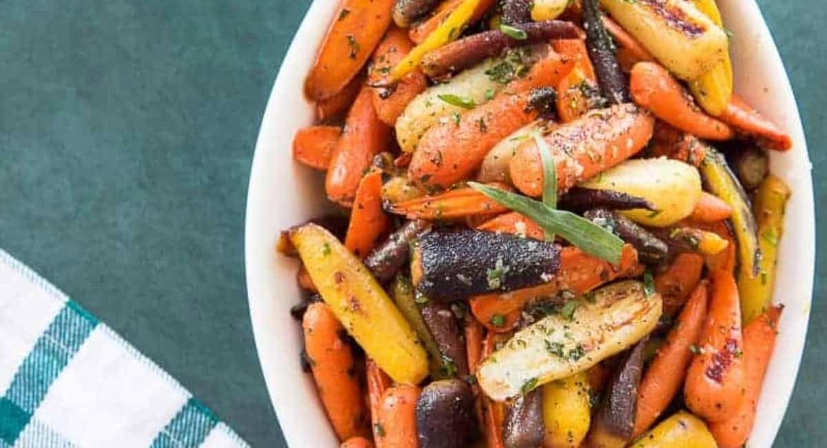 Overhead image of rainbow carrots in tarragon brown butter sauce.