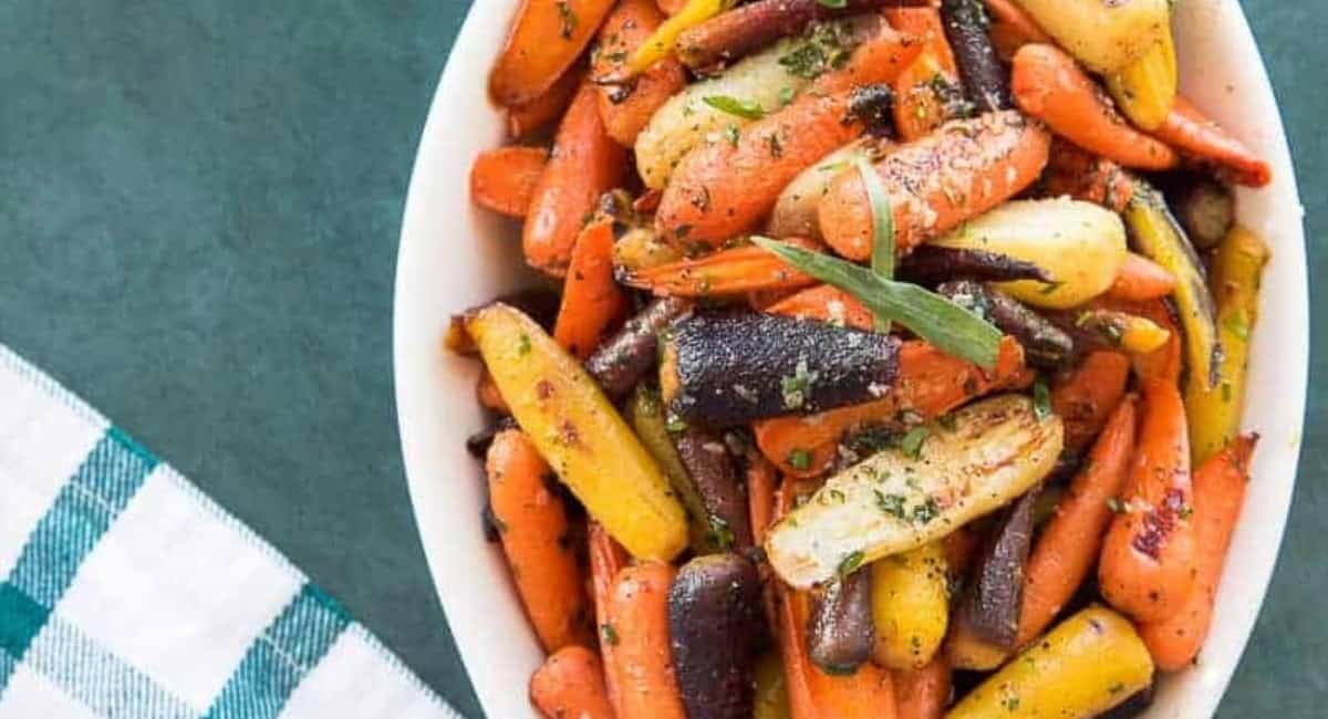 Overhead image of rainbow carrots in tarragon brown butter sauce.