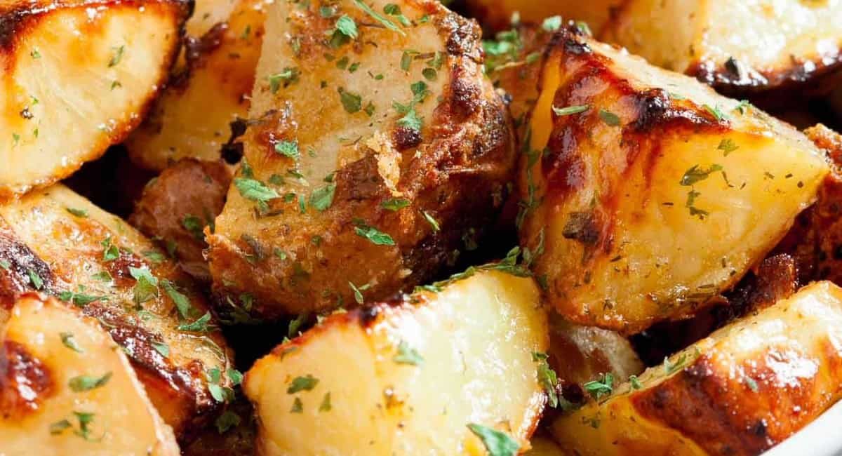 Up close image of ranch roasted potatoes with garnish.
