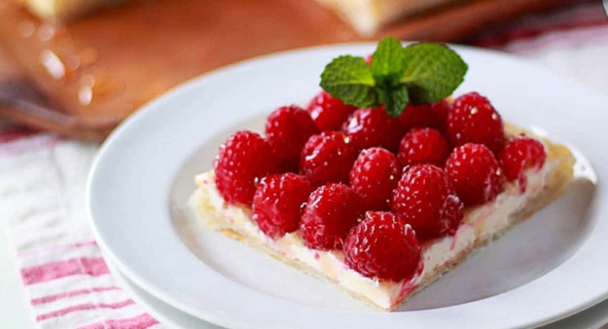 Up close image of raspberry tart with garnish.
