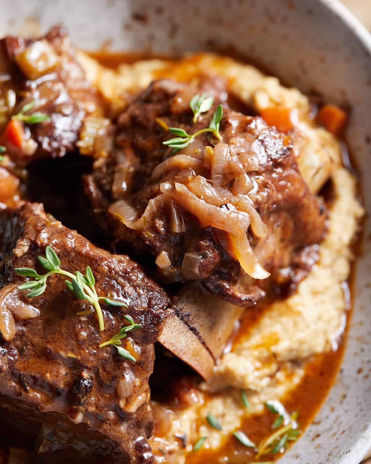 Up close image of red wine short ribs with garnish.