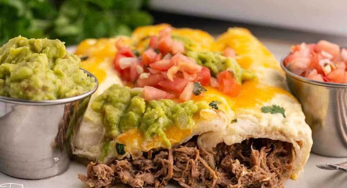 Up close image of creamy shredded beef enchiladas.