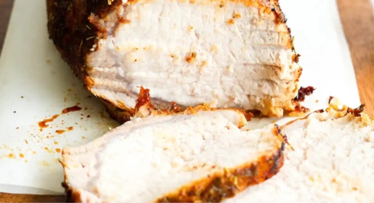 Up close image of oven-roasted pork loin with dijon gravy.