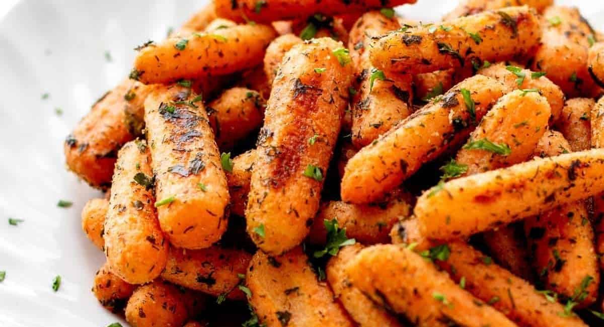 Up close image of roasted ranch baby carrots with garnish.