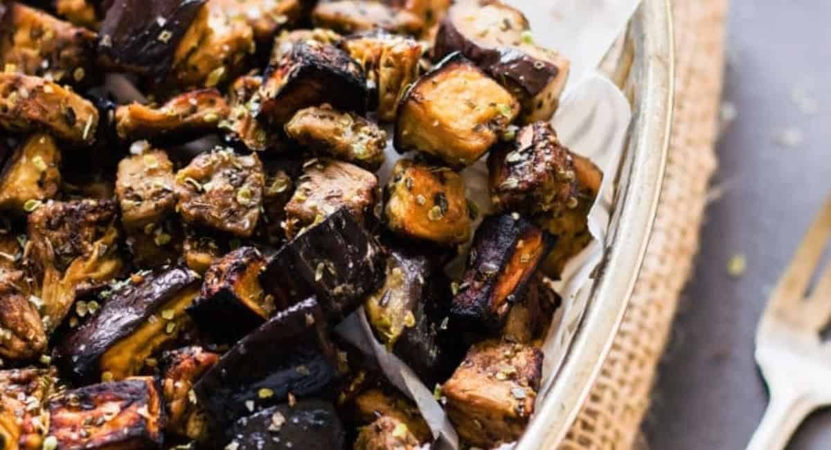 Overhead image of oven roasted eggplant cubes with balsamic vinaigrette.