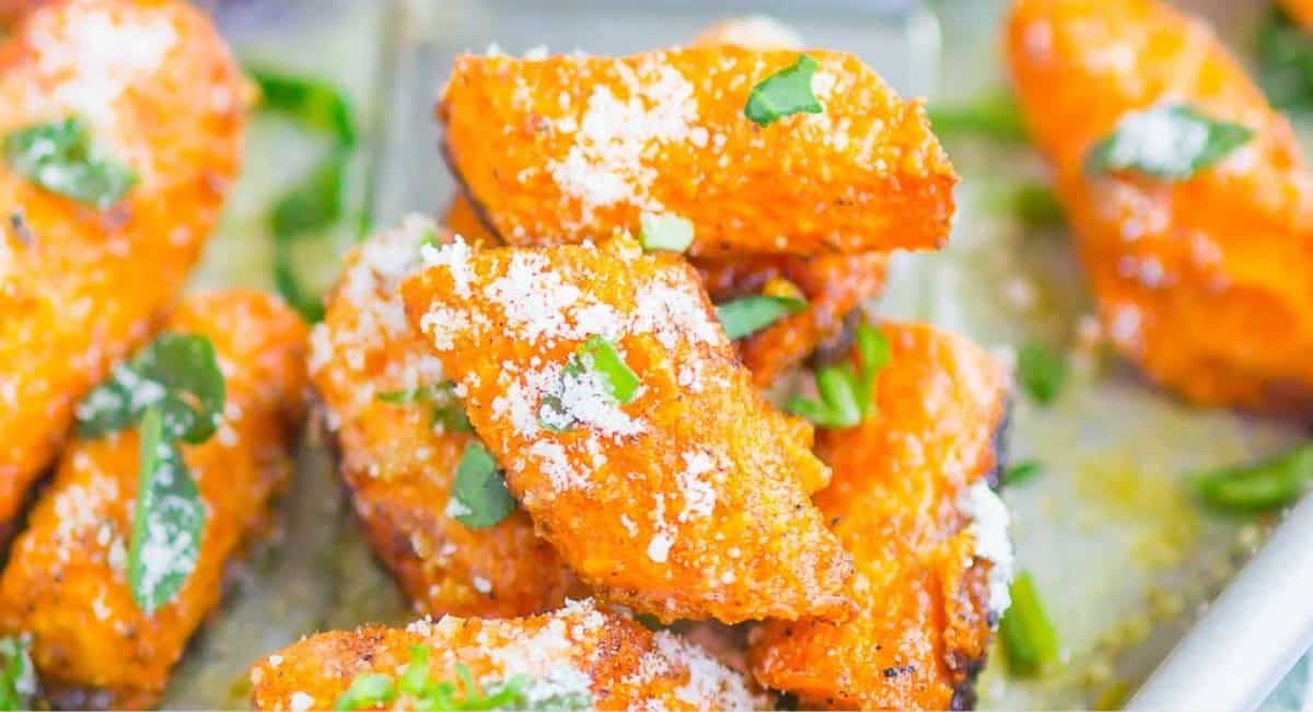 Up close image of roasted garlic parmesan carrots with garnish.