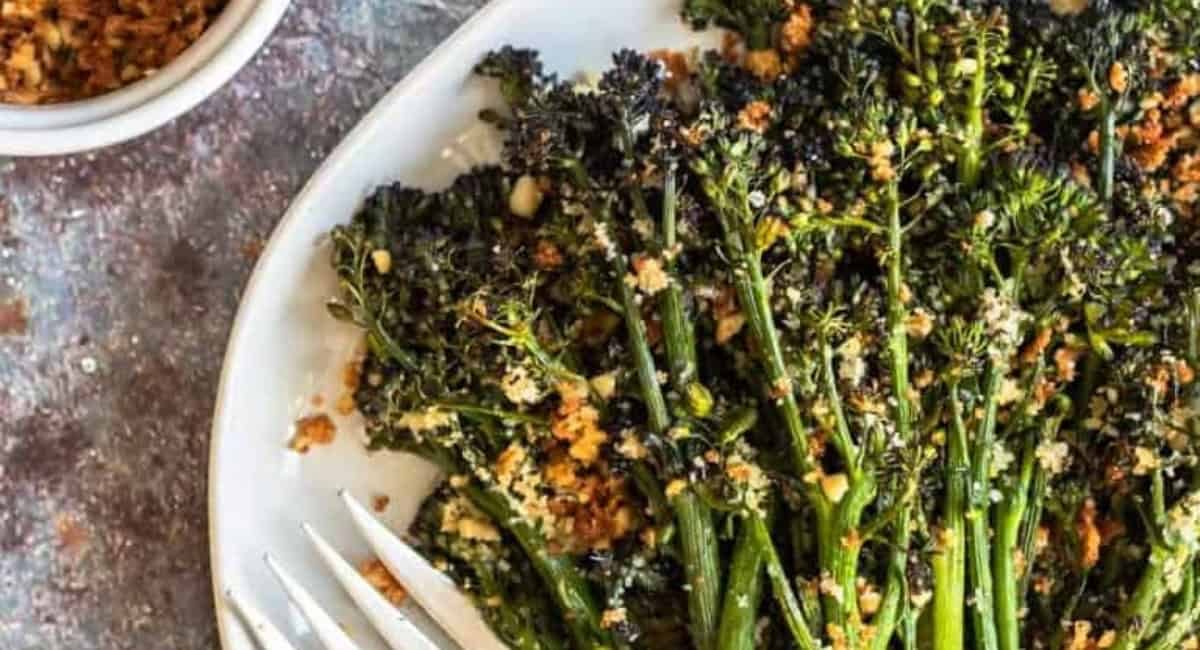 Overhead up close image of roasted broccolini with parmesan-pine nut pangritata.