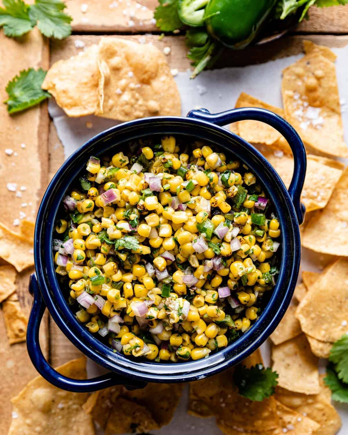 overhead shot of roasted chili corn salsa in a bowl with tortilla chips