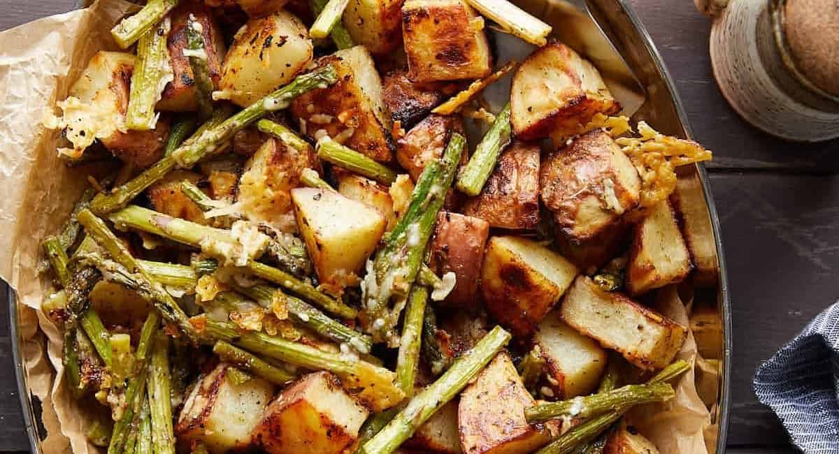 Overhead image of roasted potatoes and asparagus with parmesan.