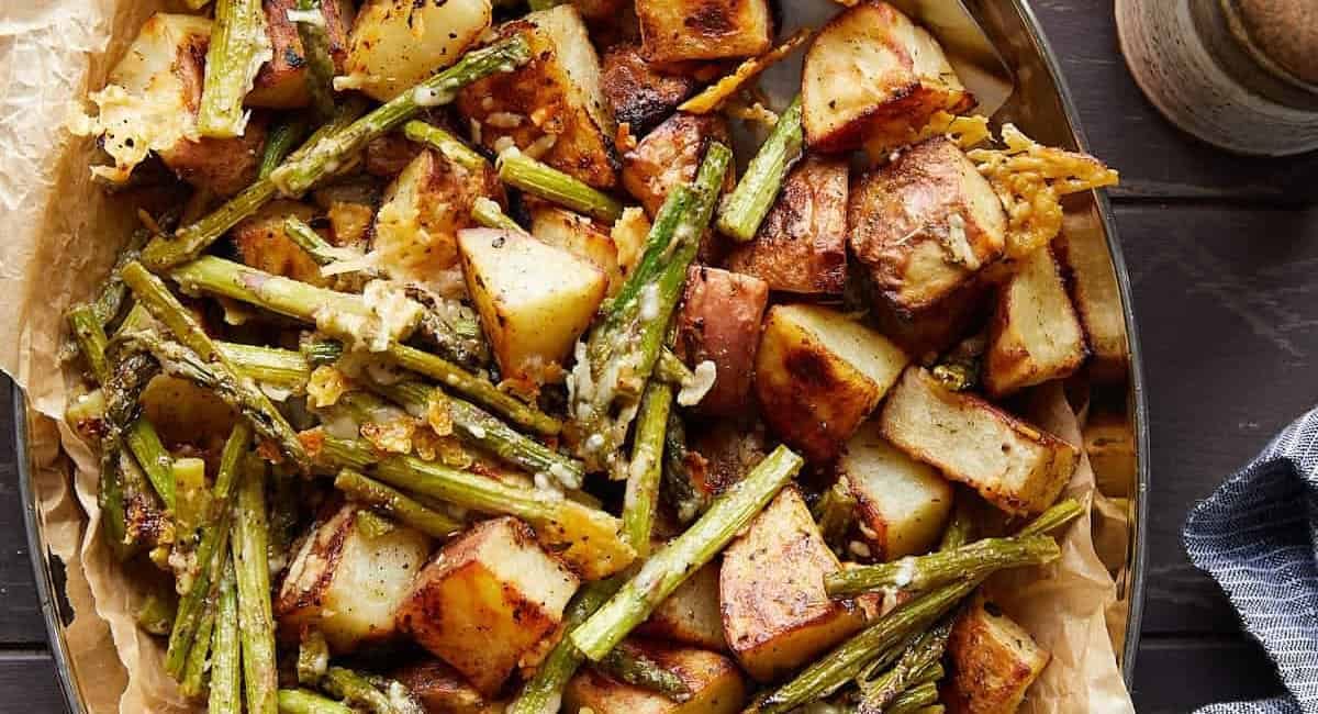 Overhead image of roasted potatoes and asparagus with parmesan.