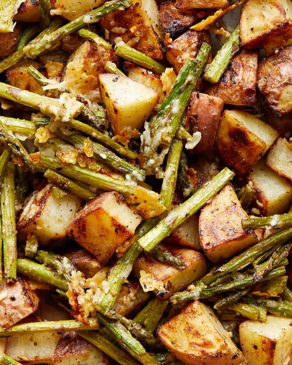 Up close image of roasted potatoes and asparagus.