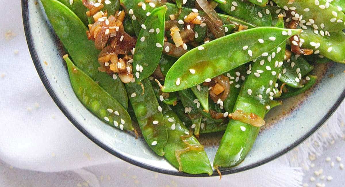 Overhead image of sautéed snow peas.