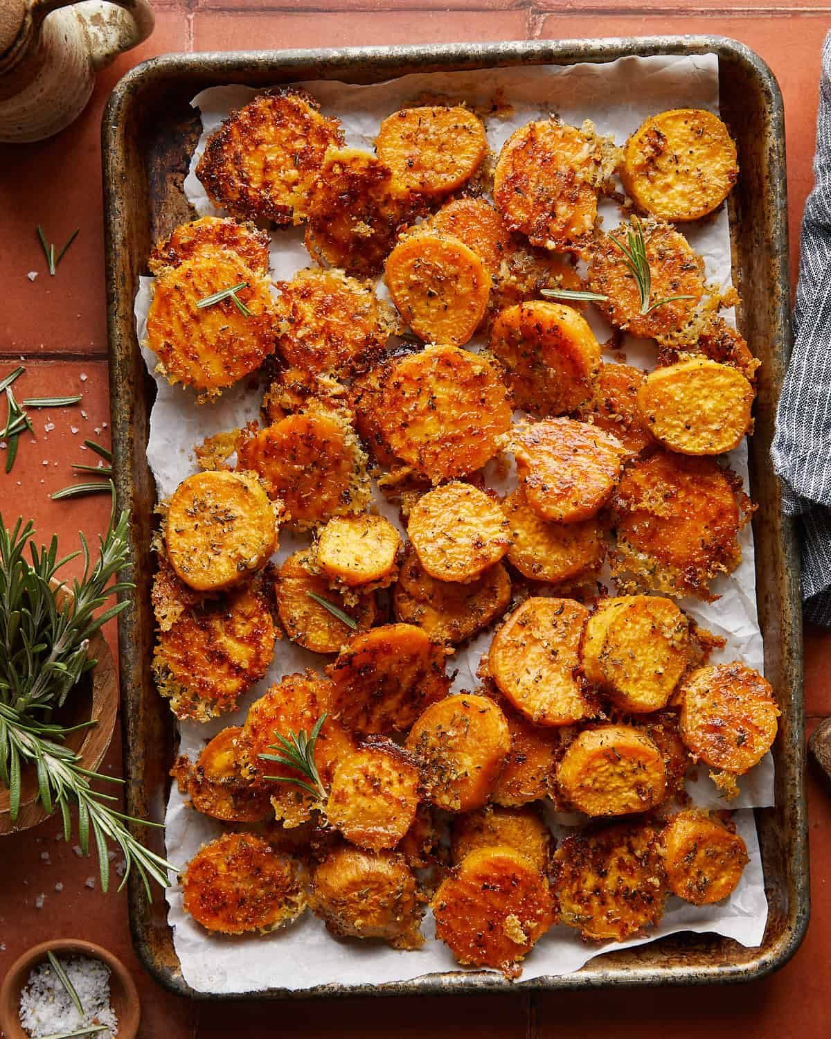 Overhead image of savory roasted sweet potatoes with garnish.