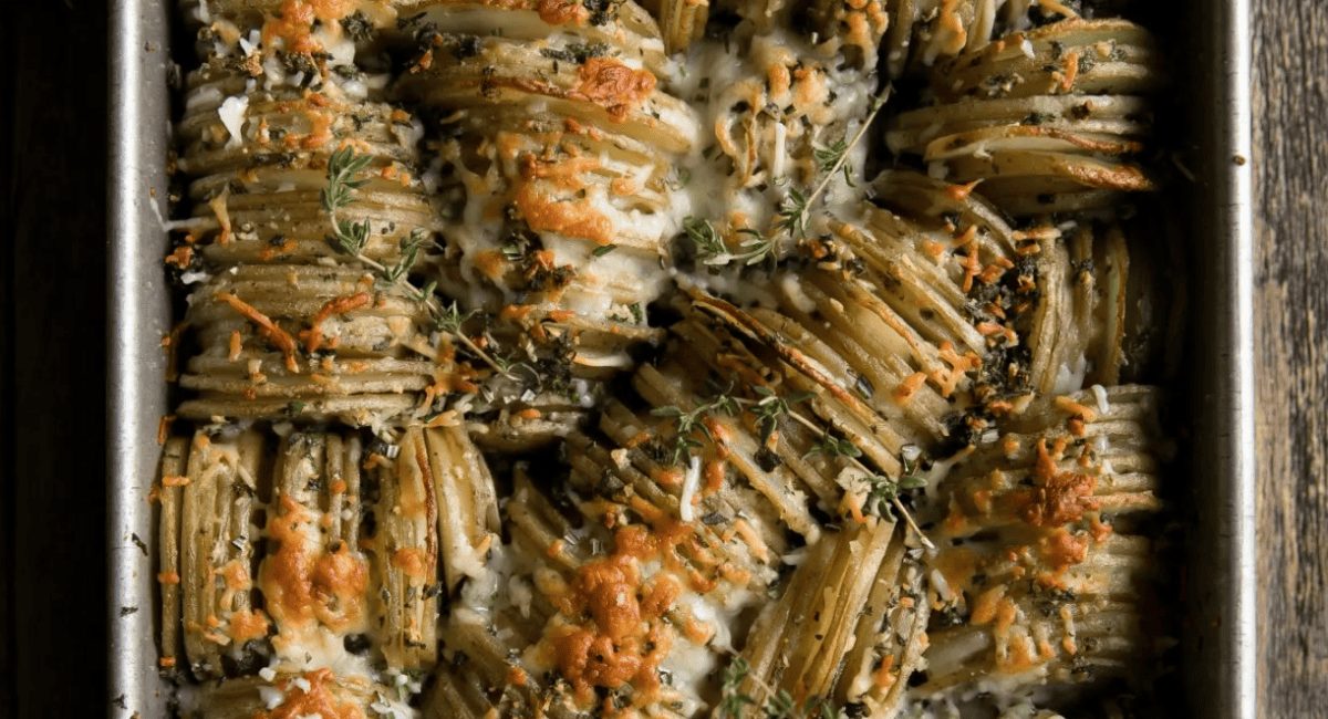 Overhead image of crispy herb roasted butter hasselback potatoes.