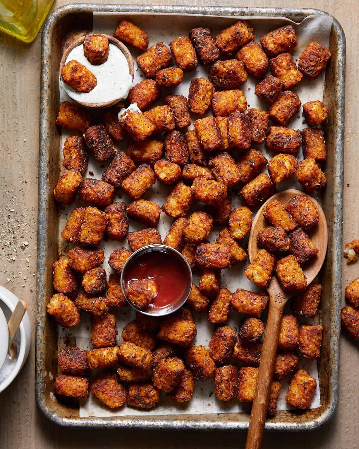 Seasoned tater tots on baking sheet.