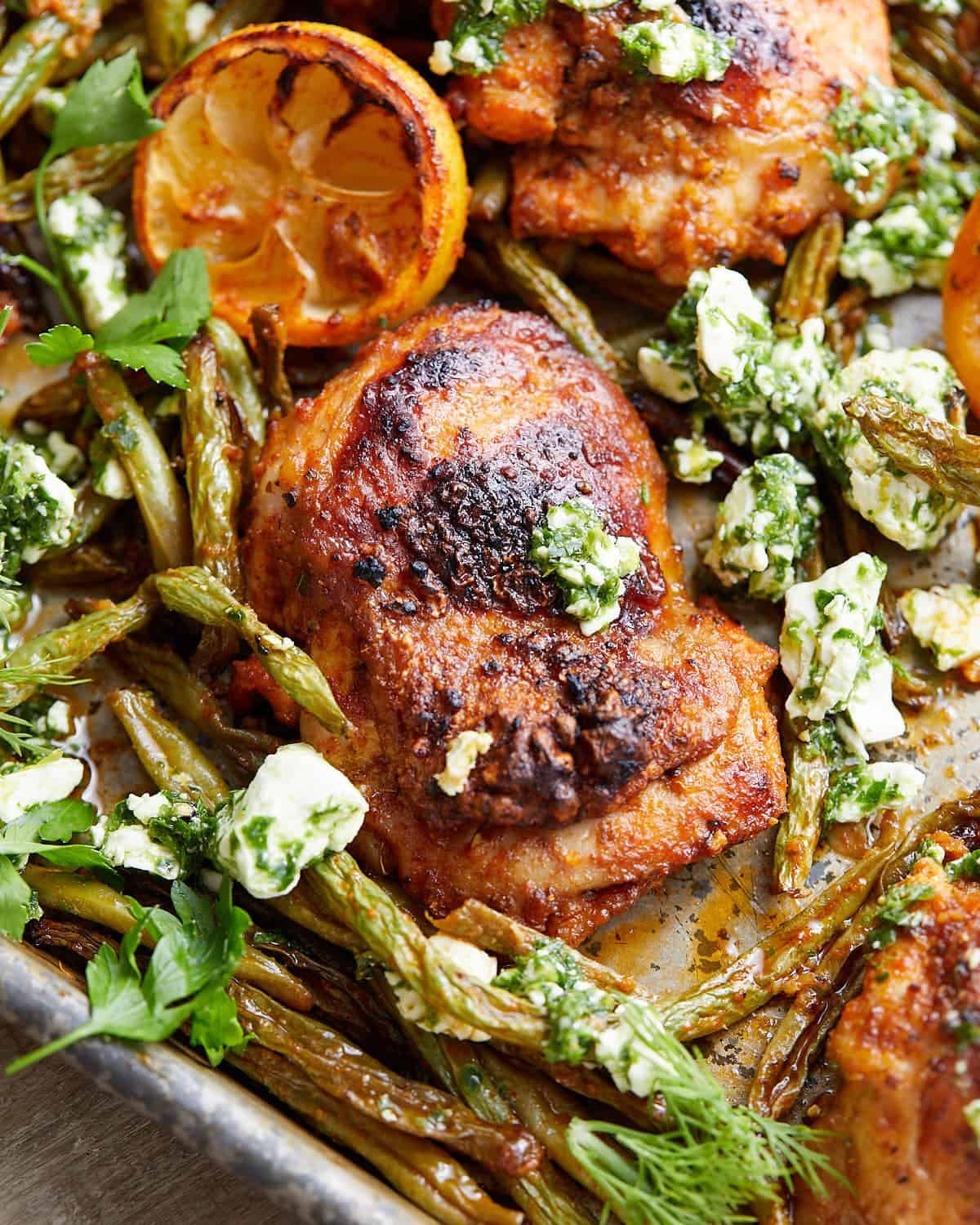 Up close image of sheet pan chicken and green beans.