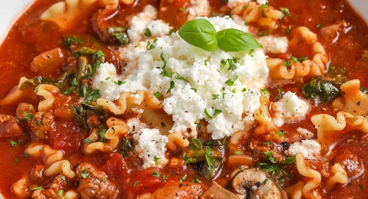 Overhead and up close image of slow cooker lasagna soup with garnish.