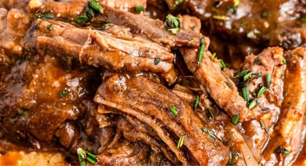 Up close image of slow cooker short ribs with garnish.