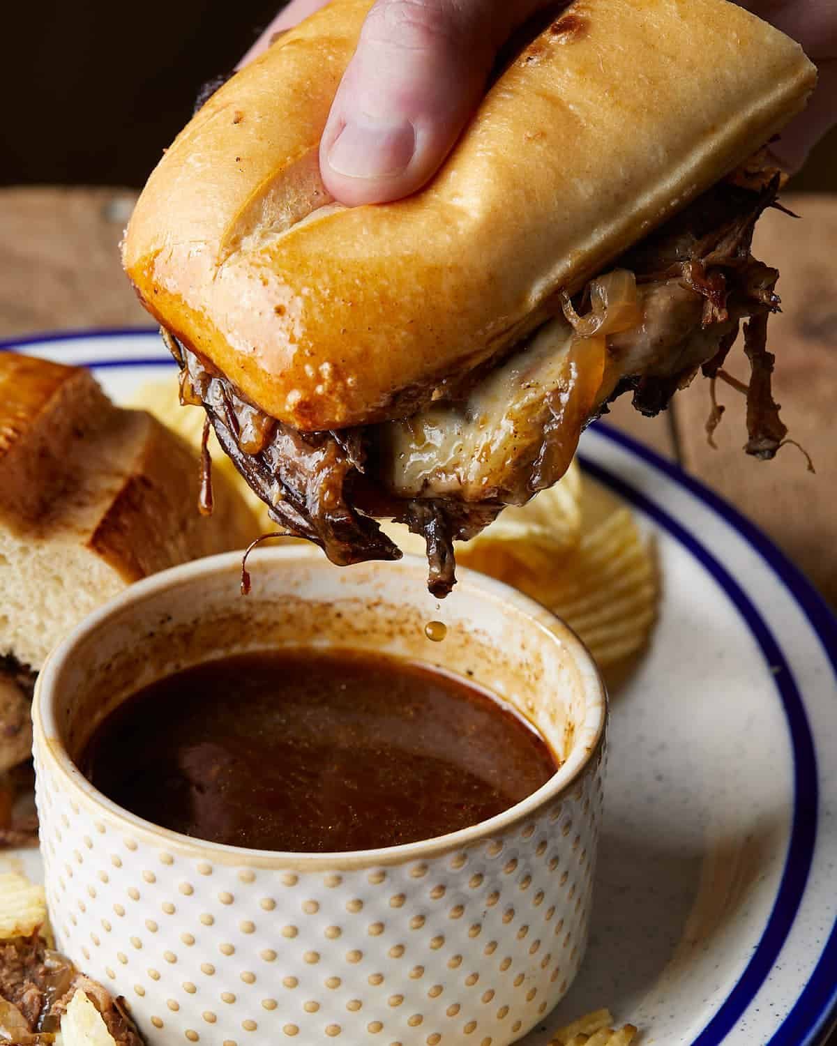 Up close image of french dip sandwich with au jus.