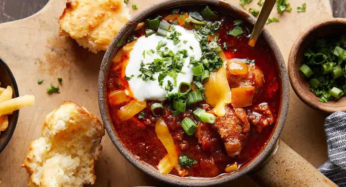 Overhead image of slow cooker no beean chili with garnish.