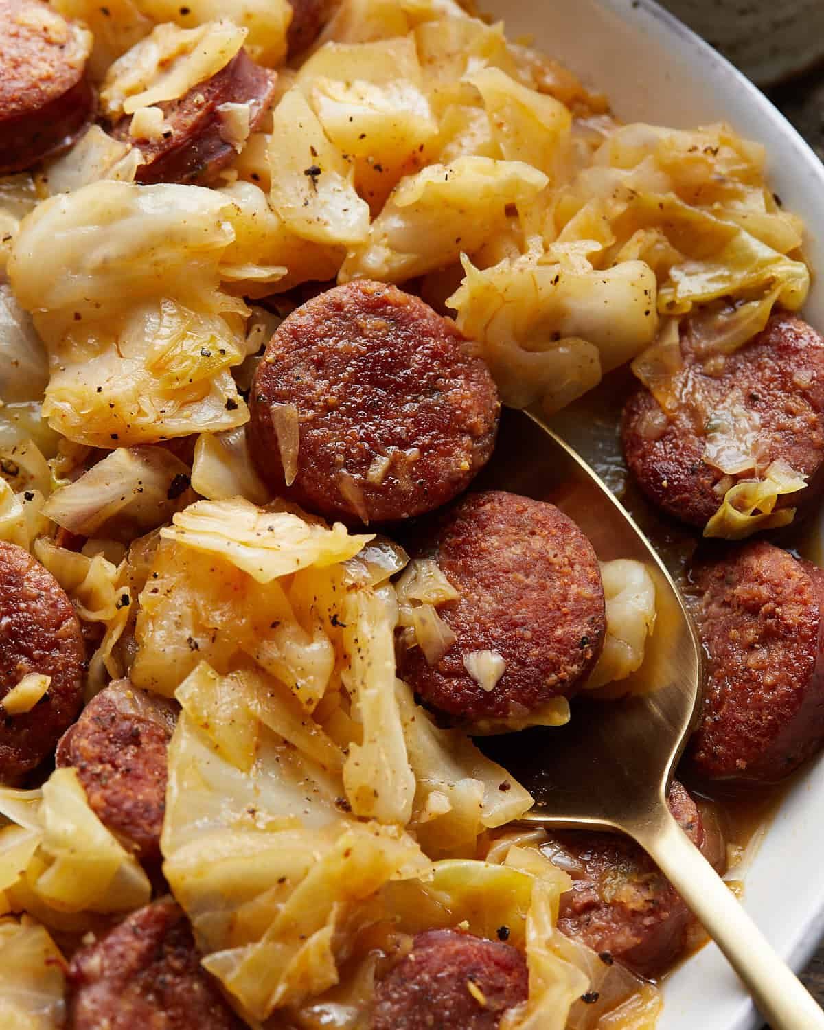 Up close image of smoked sausage and cabbage.