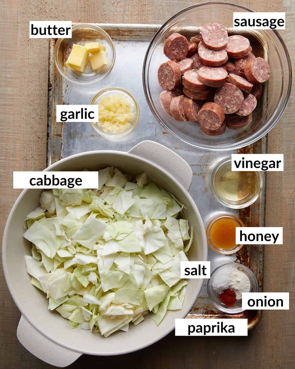 Overhead image of ingredients needed to make smoked sausage and cabbage.
