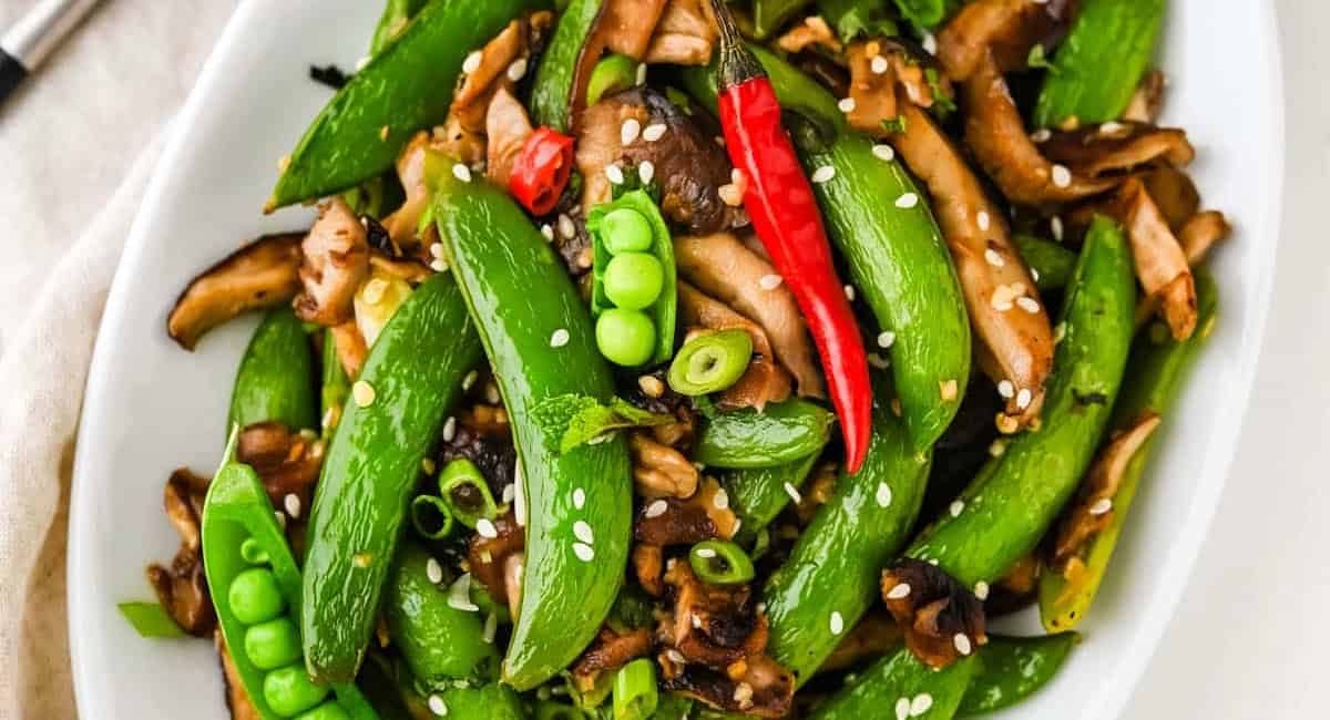 Overhead image of sugar snap peas with garnish.