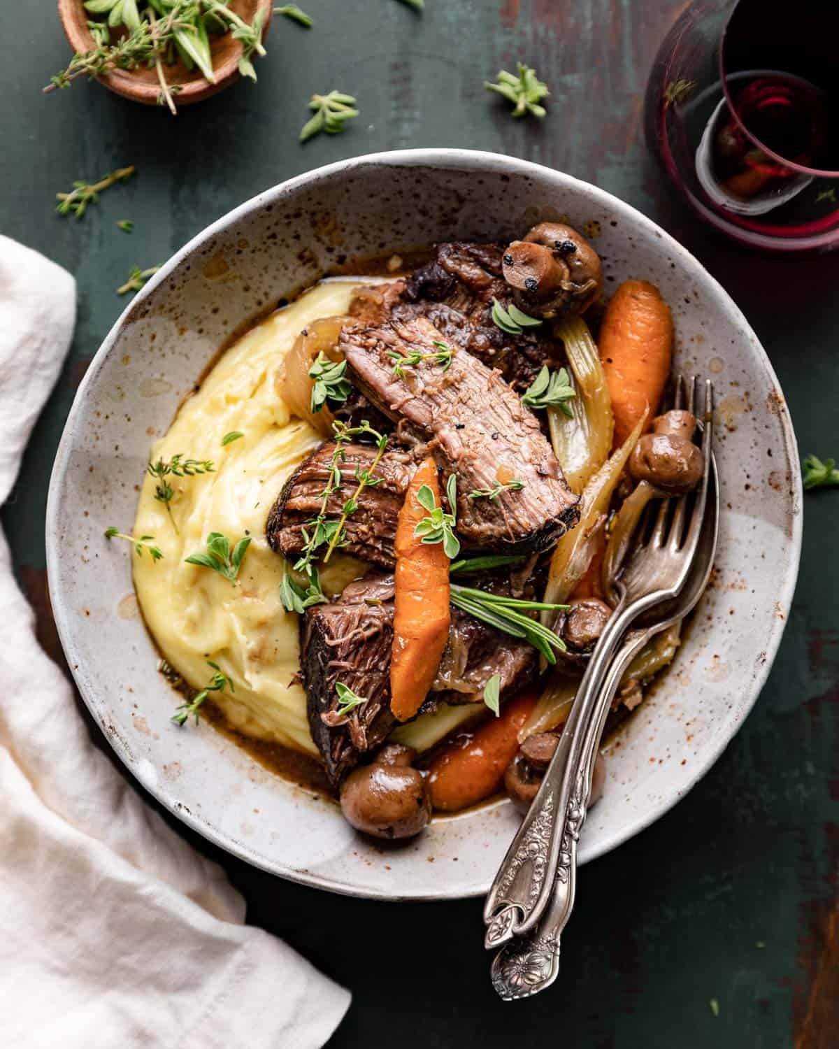 overhead of bowl with mashed potatoes, roast, and vegetables