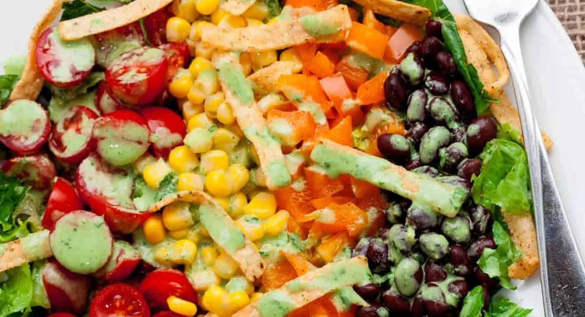 Overhead up close image of southwest chopped salad on white plate with fork.