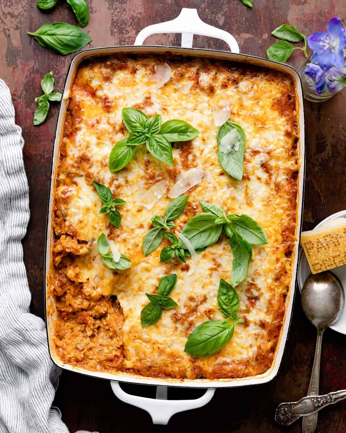 Overhead image of spaghetti squash casserole in white baking dish with garnish.